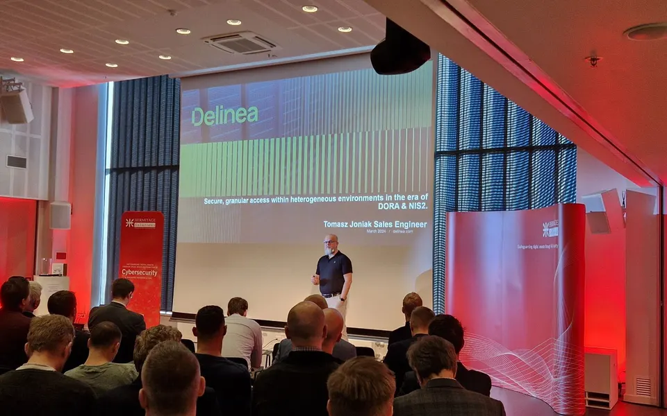 Tomasz Joniak presenting on DORA and NIS2 at the Hermitage Solutions event in Vilnius